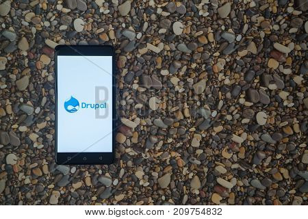 Los Angeles, USA, october 18, 2017: Drupal logo on smartphone on background of small stones