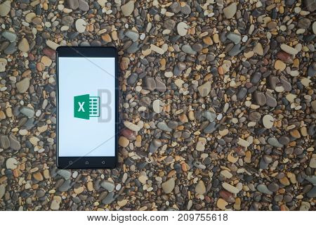 Los Angeles, USA, october 18, 2017: Microsoft office excel logo on smartphone on background of small stones