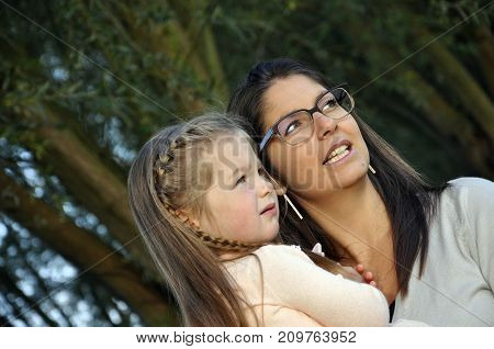 Child and mother on a beautiful morning near a grassfield