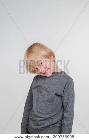 Vertical emotional portrait of caucasian boy. Handsome happy child, isolated on white background