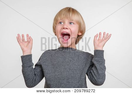 Emotional portrait of angry caucasian small boy