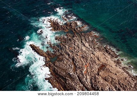 Aerial view of Geyser Rock a small island next to Dyer Island which is home to a colony of Cape fur seals off the coast of Gansbaai South Africa