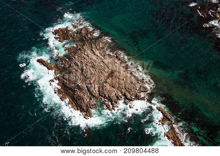 Aerial view of Geyser Rock a small island next to Dyer Island which is home to a colony of Cape fur seals off the coast of Gansbaai South Africa