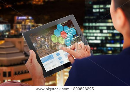 Businesswoman working on digital 3D tablet over white background against glowing modern buildings in city