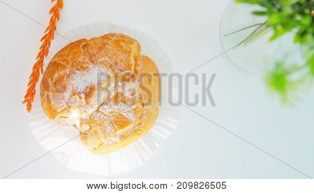 Profiteroles stuffed with pastry cream on white desk in cafe