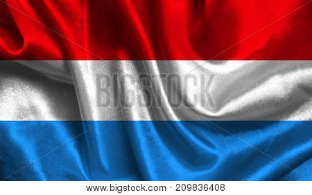 Realistic flag of Luxembourg on the wavy surface of fabric. This flag can be used in design.