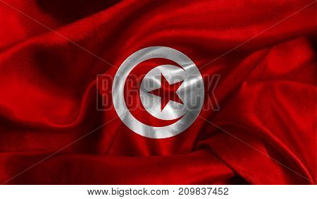 Realistic flag of Tunisia on the wavy surface of fabric. This flag can be used in design.