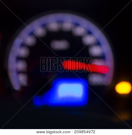 Defocused modern car dashboard. Bokeh background. Concept of drunkenness driving. Over speed