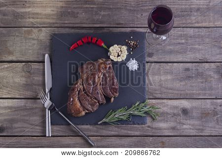Grilled Beef Steak With Vegetables On The Stone Plate With A Red Wine. Top View. Copy Space