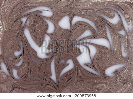 Liquid gold marbled pattern. Beige background. Golden powder