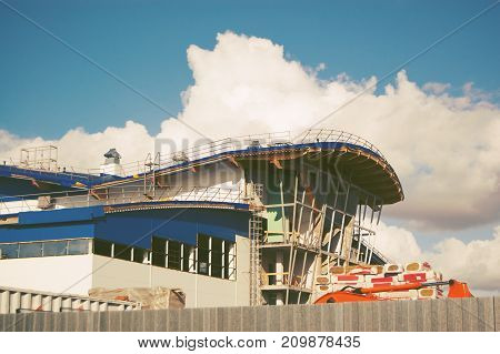building of the sports complex under construction behind the fence