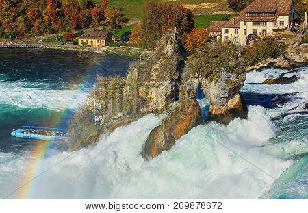 Laufen, Switzerland - 17 October, 2017: a rainbow over the Rhine Falls, view from the Laufen castle. The Rhine Falls is the largest waterfall in Europe, located on the border between the Swiss cantons of Zurich and Schaffhausen.