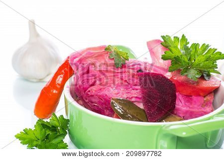 Marinated cabbage with beets and other vegetables on a white background