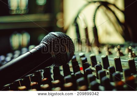 the microphone rests on an audio mixer