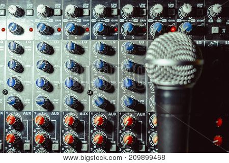 the microphone rests on an audio mixer