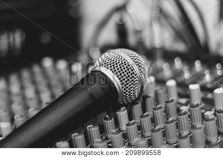 the microphone rests on an audio mixer