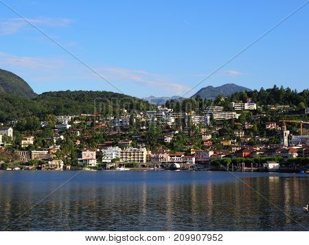 ASCONA travel city in SWITZERLAND with scenic view of beauty Lake Maggiore at canton of Ticino and of alpine mountain range landscape at swiss Alps in 2017 warm sunny summer day Europe on July.