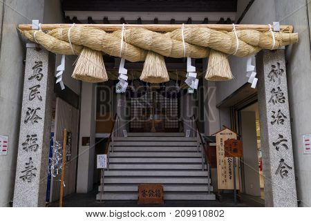 Hiroshima, Japan - May 23, 2017:  Shimenawa, special plaited rope and shime, strips of white paper, placed at the entrance of a holy places to ward off evil spirits
