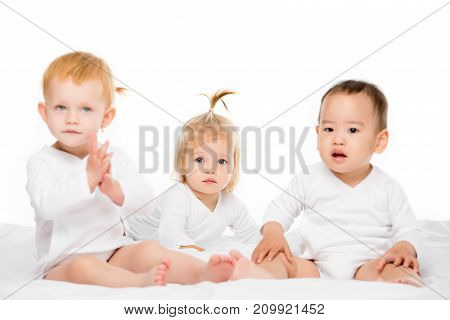 multiethnic toddler asian boy and caucasian girls isolated on white