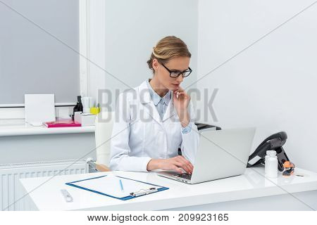 Female Doctor Using Laptop