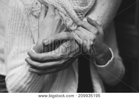 her husband gently hugs her girlfriend tenderly