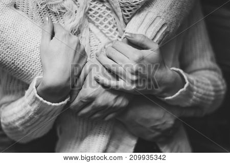 her husband gently hugs her girlfriend tenderly
