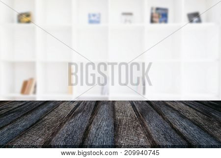 Empty wooden table and blur background of abstract in front of modern library or knowledge source can be used Mock up for display of product or for montage.
