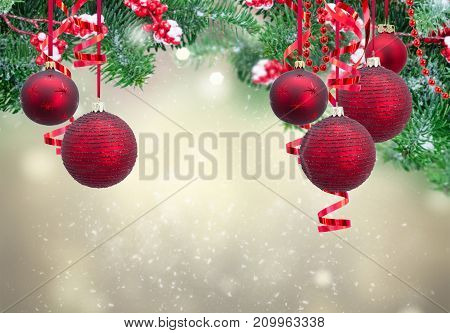 Red christmas balls and evergreen fir tree frame on gray winter background