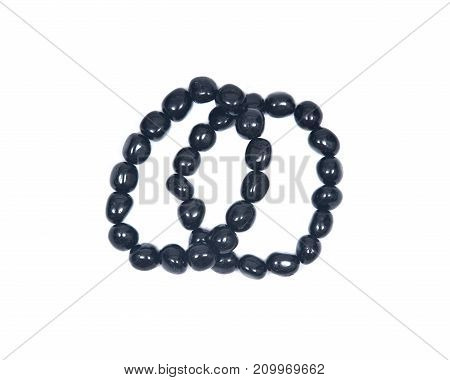 Black Tourmaline Bracelet isolated on white background. Polished tumbled black tourmaline stones strung on stretch cord.