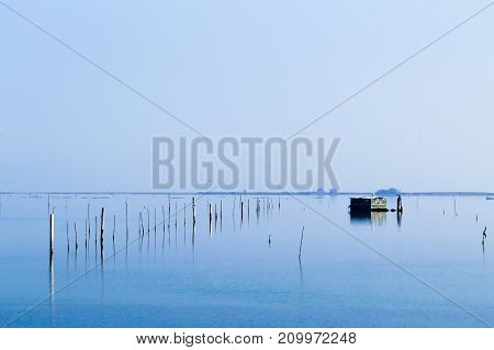 Shellfish farming from Po river lagoon Italy. Scardovari beach. Italian rural landscape