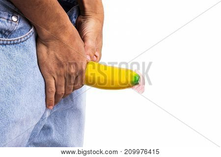 A Big Banana Sticks Out Of A Blue Jean Demonstraiting A Penis With A Piece Of Condom