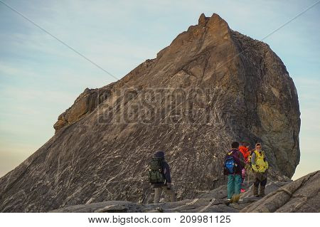 Mount Kinabalu,Ranau,Sabah.Malaysia-March 12,2016:Climber passing trail from the St John's peak during morning at the summit of Mount Kinabalu,Sabah,Malaysia.