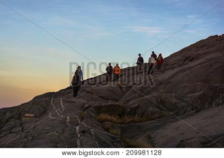 Mount Kinabalu,Ranau,Sabah,Malaysia-March 12,2016:Group of adventure climber moving down from the summit of Mountain Kinabalu during sunrise at the majestic Mountain Kinabalu,Sabah,Malaysia.