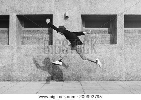 Asian guy midair jumpshot outdoors
