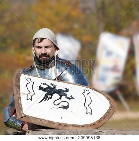 Russia Kamchatka - OCTOBER 01 2017: The first Kamchatka military historical festival in the city of Petropavlovsk-Kamchatsky. Medieval knight in armor without a helmet waiting for battle