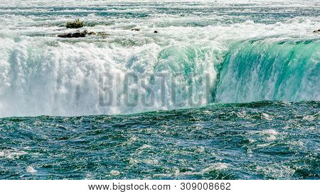 Dangerous Rapids Falling Over Edge At Top Of Horeshoe Falls At Niagara Falls, Ontario, Canada.