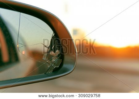 Side Mirror Of The Car With A View Back. Broken Mirror Close Up.