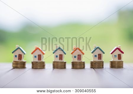 Mini House On Stack Of Coins,money And House,  Mortgage, Savings Money For Buy House And Loan To Bus