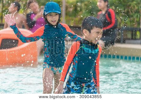 Asian Siblings Is Running And Chasing In Swimming Pool