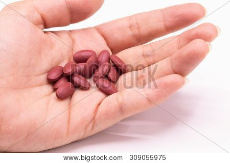 Ferrous Fumarate Pills With Vitamins For Treat Iron Deficiency Anemia In Hand On White Background.