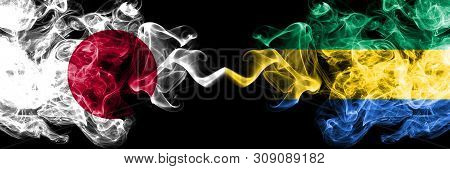Japan Vs Gabon, Gabonese Smoky Mystic Flags Placed Side By Side. Thick Colored Silky Smokes Combinat
