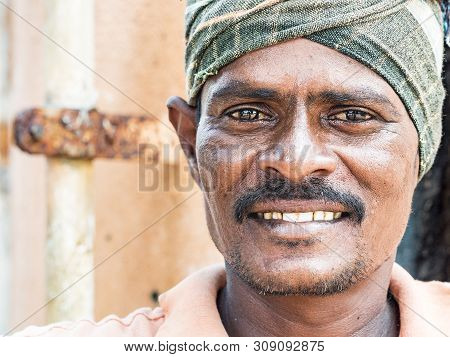 Puduchery, India - December Circa, 2018. Portrait Of Unidentified Indian Worker With Orange Dress Lo