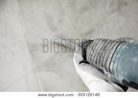 Abstraction Photo Of Noisy Repair. Electric Tool In The Hands Of A Construction Worker, Gadder Again