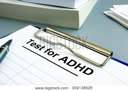 Test For Adhd Form With Pen And Clipboard.