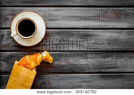 Breakfast With Croissant In Paper Bag And Cup Of Coffee On Wooden Background Top View Mock Up