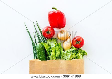 Buying Fresh Vegetables In Paper Bag On White Background Top View