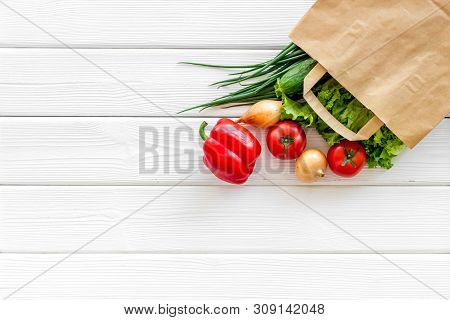 Buying Fresh Vegetables In Paper Bag On White Wooden Background Top View Copyspace