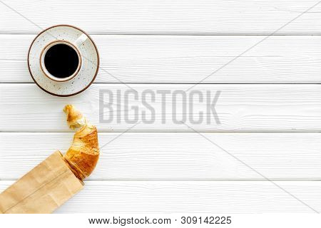 Breakfast With Croissant In Paper Bag And Cup Of Coffee On White Wooden Background Top View Mock Up