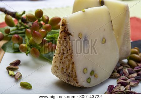 Italian Provolone Or Provola Cheese Made In Sicily With Tasty Green Bronte Pistachio Nuts Served On
