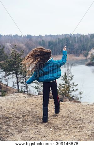 Young Beautiful Girl Posing On A Background Of Lake